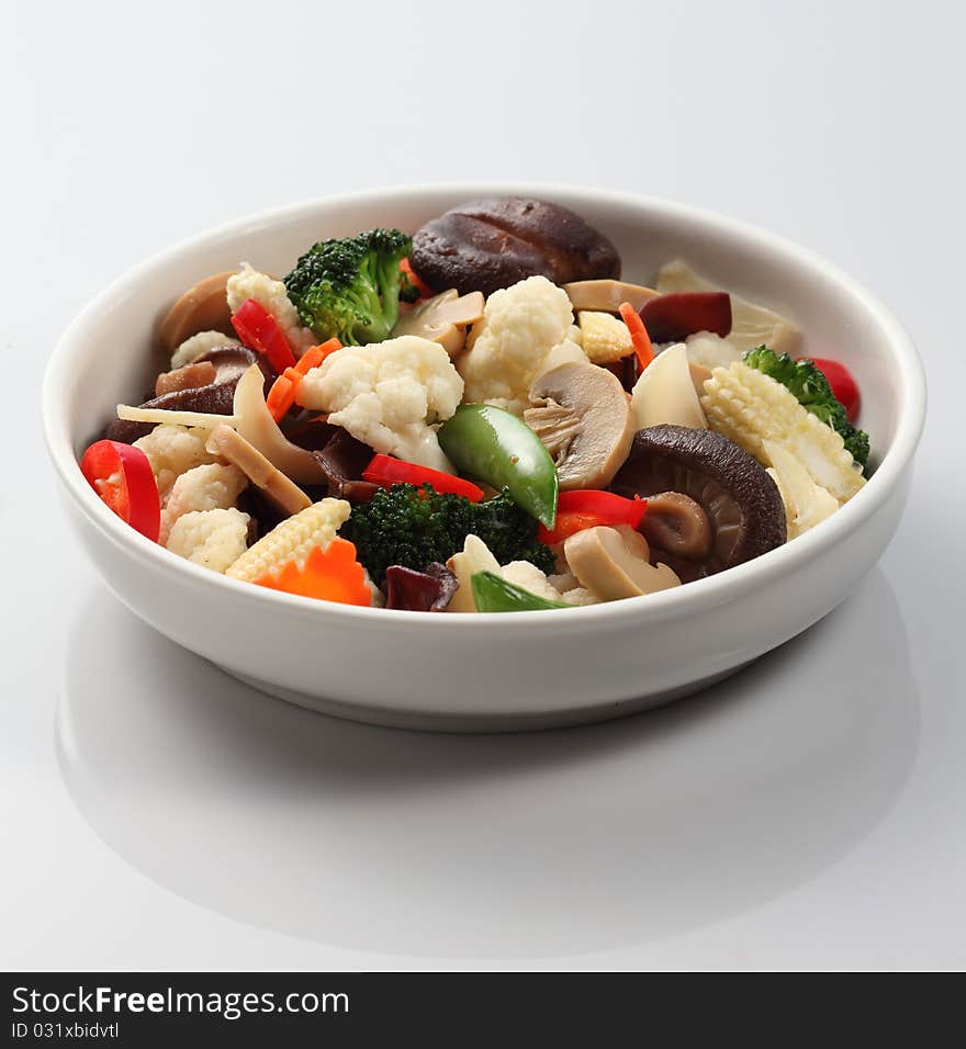 A bowl of oriental stir-fried vegetable with mushroom. A bowl of oriental stir-fried vegetable with mushroom