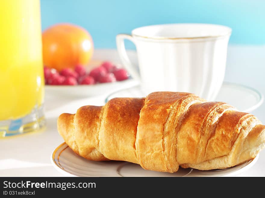 Breakfast. A cup of coffee, croissant, orange juice and berries. Breakfast. A cup of coffee, croissant, orange juice and berries