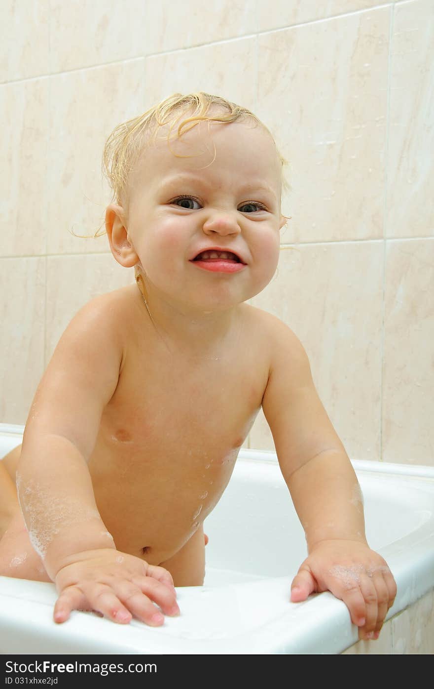 Little boy in bath room, he makes faces. Little boy in bath room, he makes faces