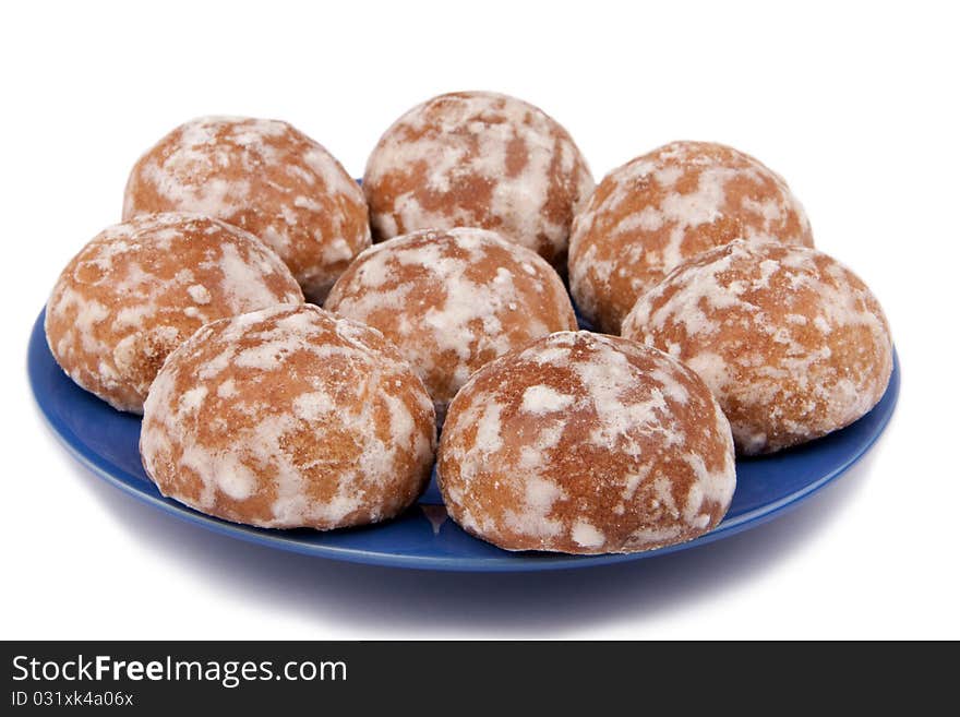 The glazed spice-cakes on a dark blue saucer