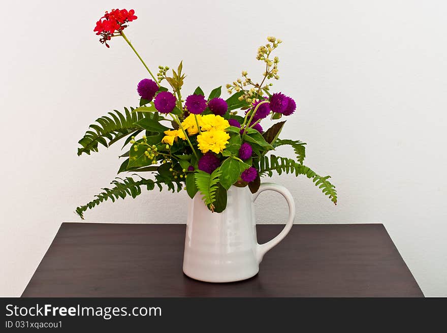 Colorful flowers in white cup, Thailand.