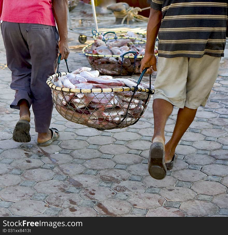 Fishermen with full basket of fish