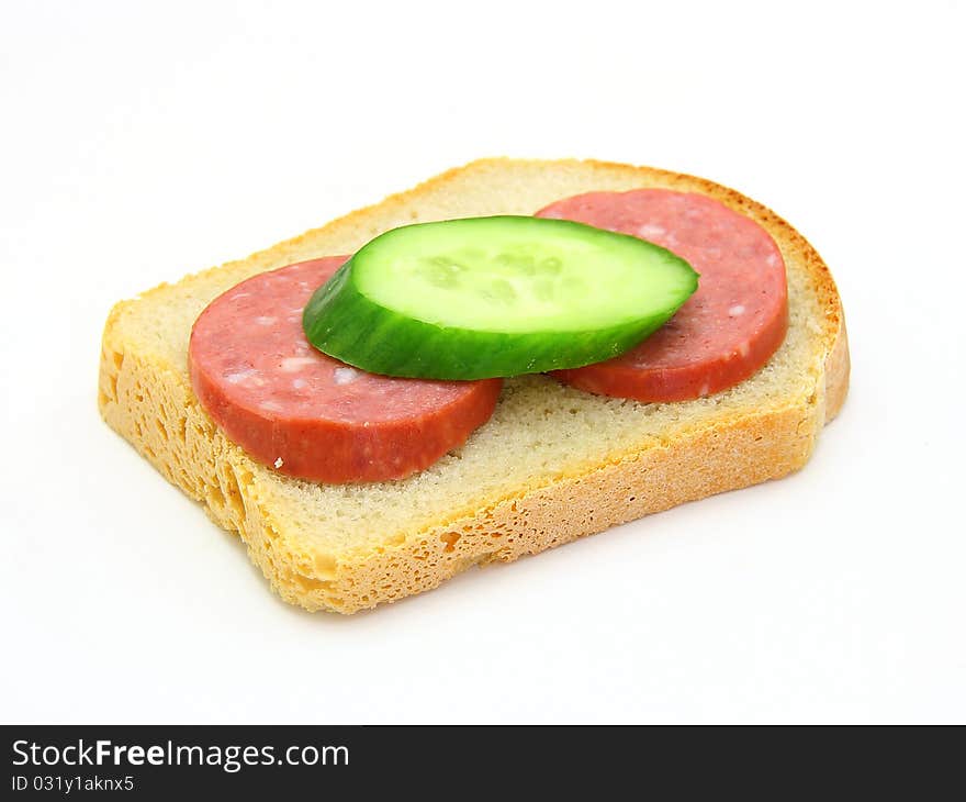 Sandwich with sausage and a cucumber