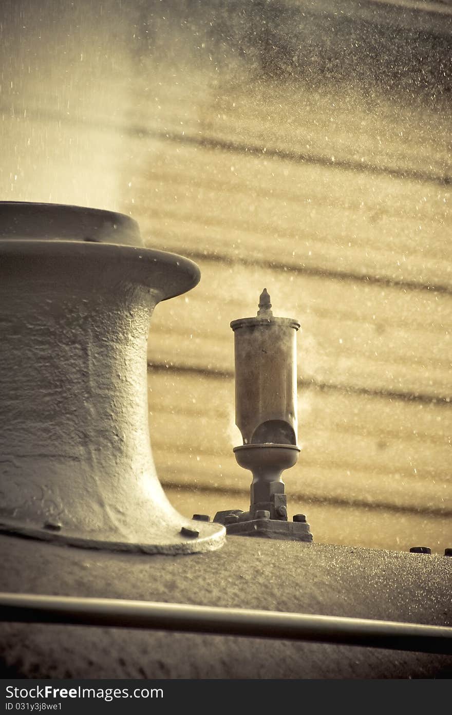 Steam escaping from the funnel of a vintage railroad engine