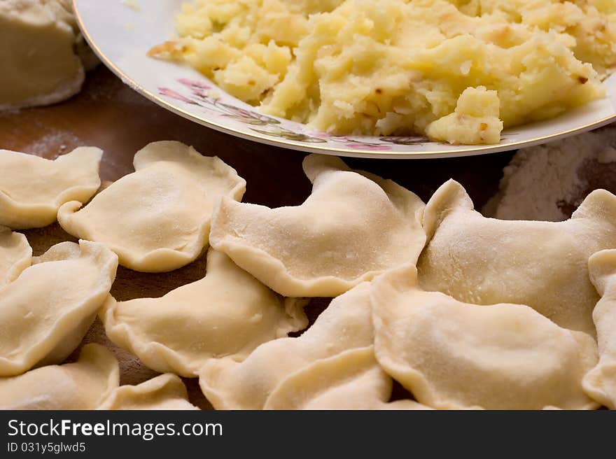 Traditional Ukrainian domestic dumplings filled with potatoes on the table closeup