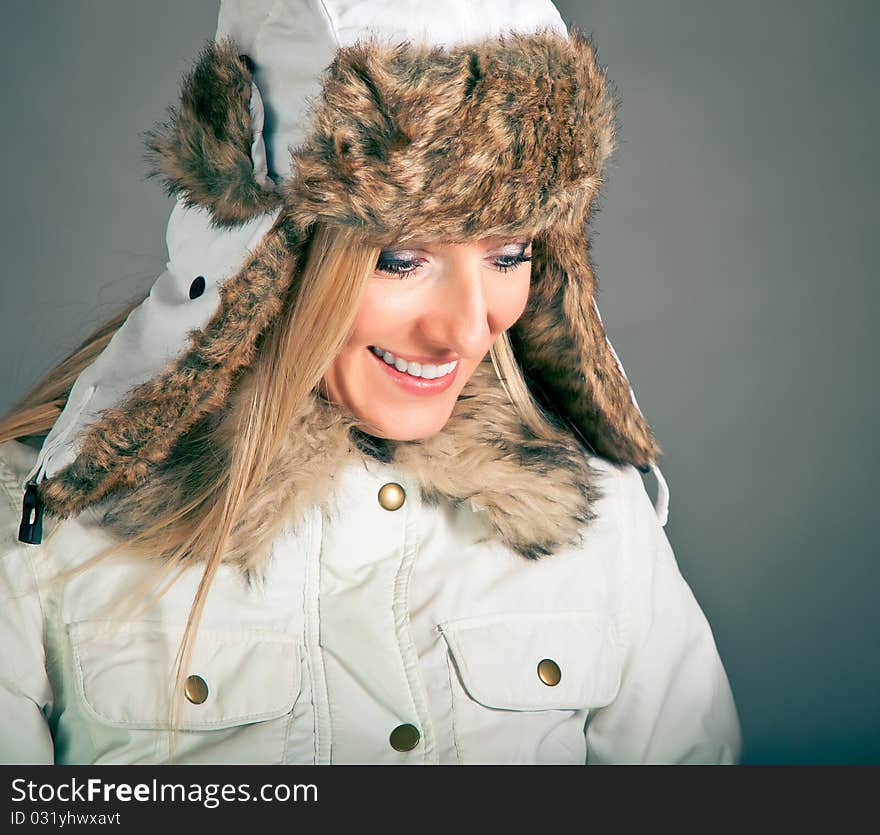 Portrait of beautiful blond woman in warm clothes on blue background. Portrait of beautiful blond woman in warm clothes on blue background