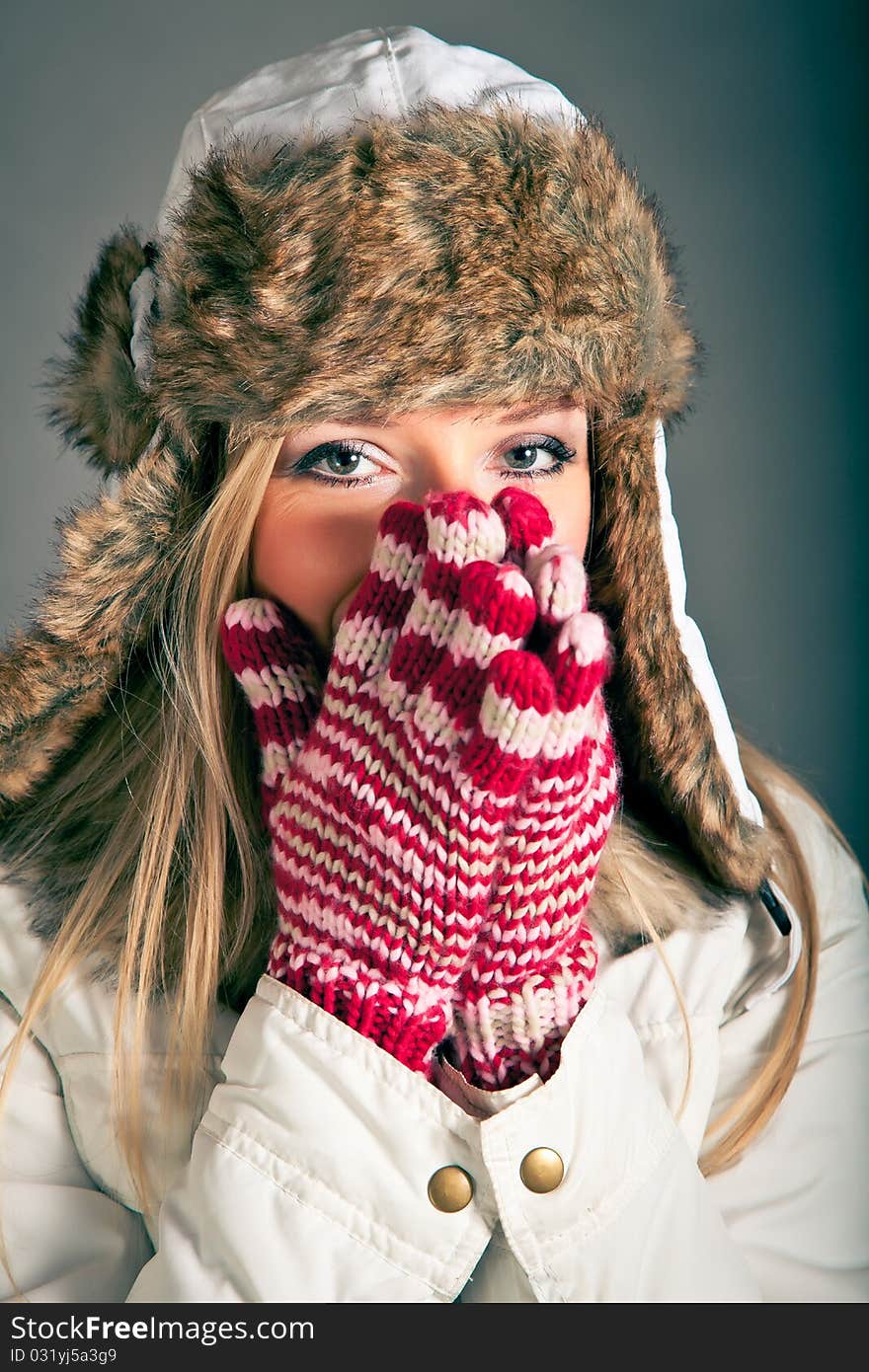 Portrait of beautiful blond woman in warm clothes on blue background. Portrait of beautiful blond woman in warm clothes on blue background