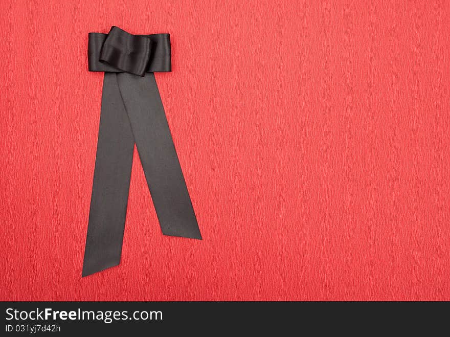 Black bow on red background