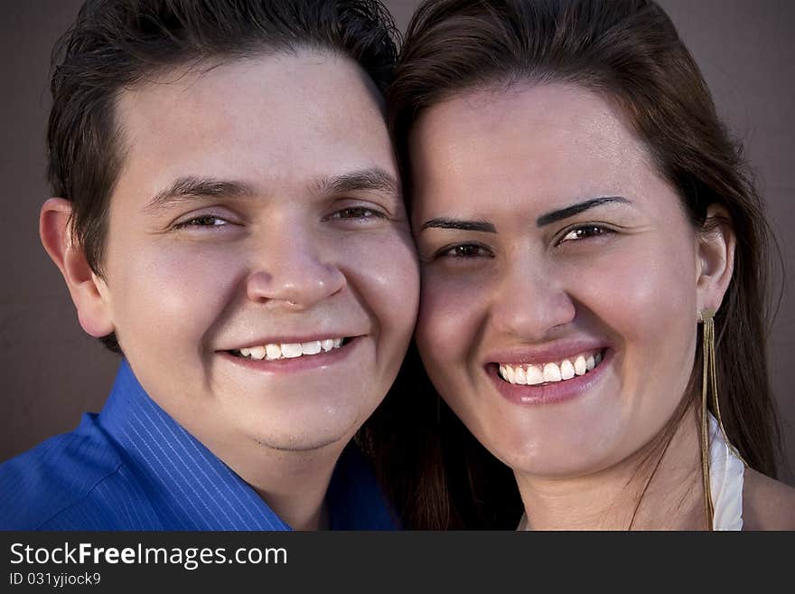 Happy Couple Smiling to the Lens and Enbracing.