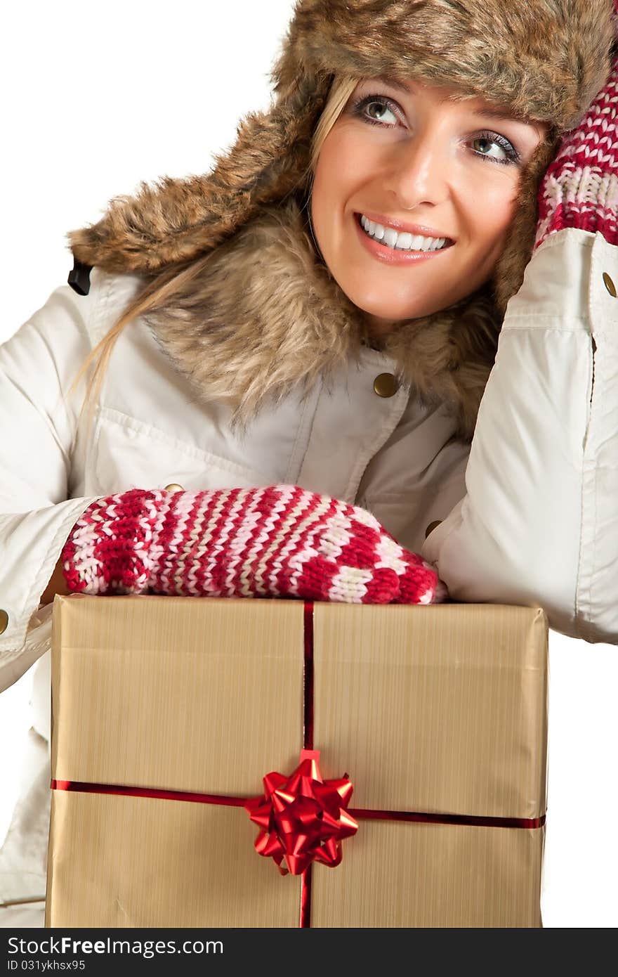 Caucasian blond woman in furry hat and christmas gifts isolated on white