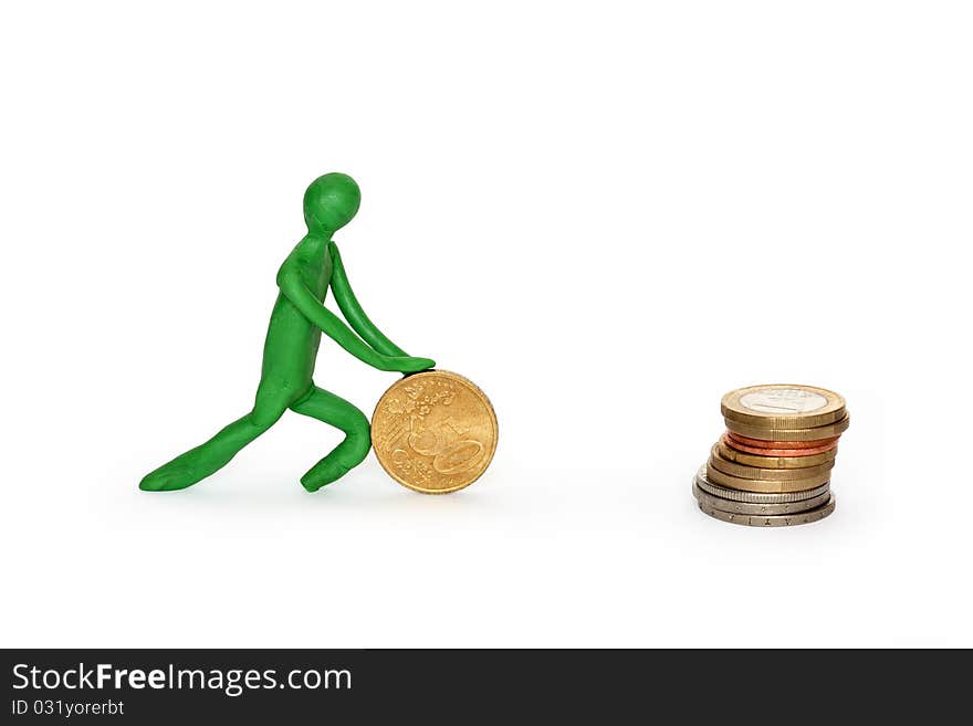 Green plasticine man rolling coin to stack of coins. Isolated on white with clipping path. Green plasticine man rolling coin to stack of coins. Isolated on white with clipping path