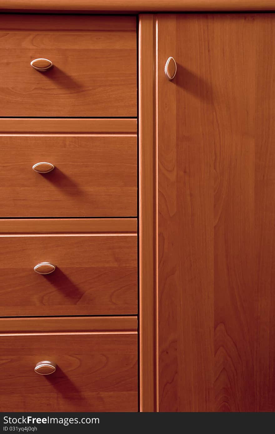 Detail of wooden chest of drawers. Detail of wooden chest of drawers