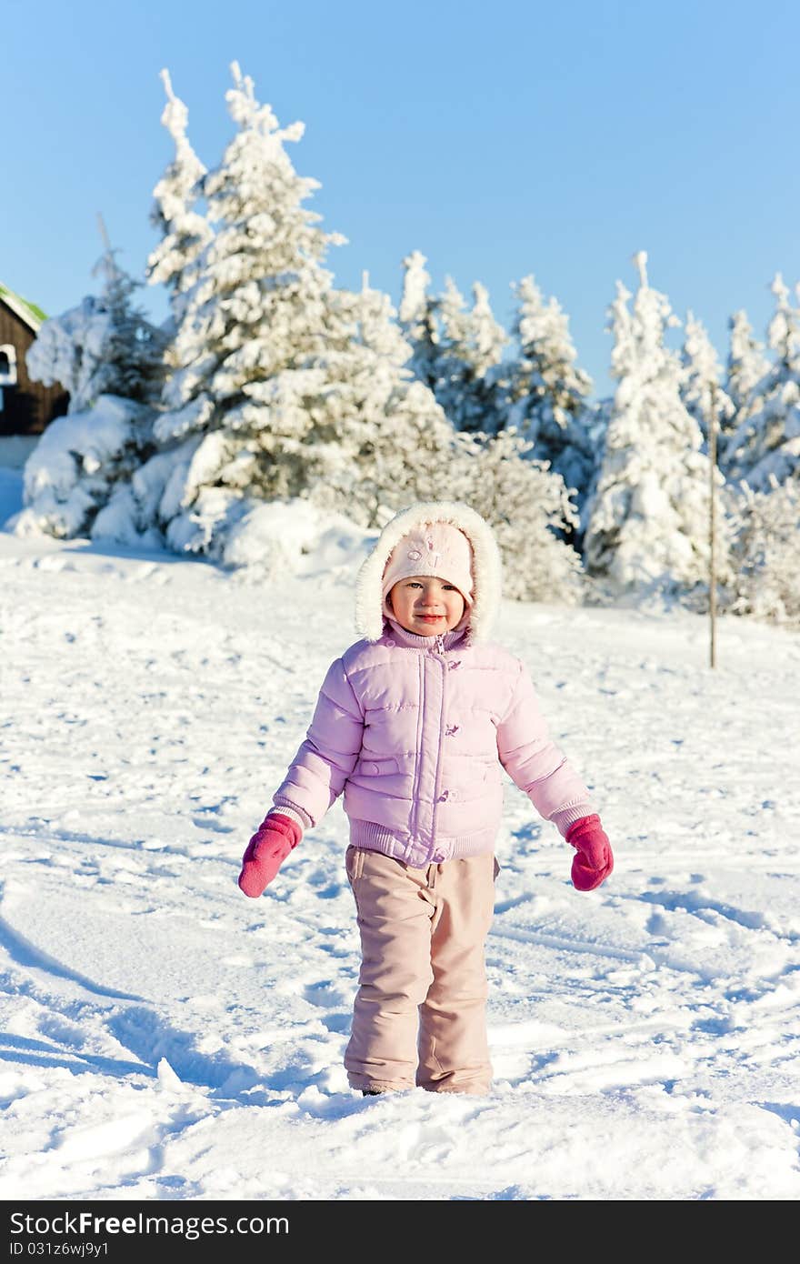 Little girl in winter mountains