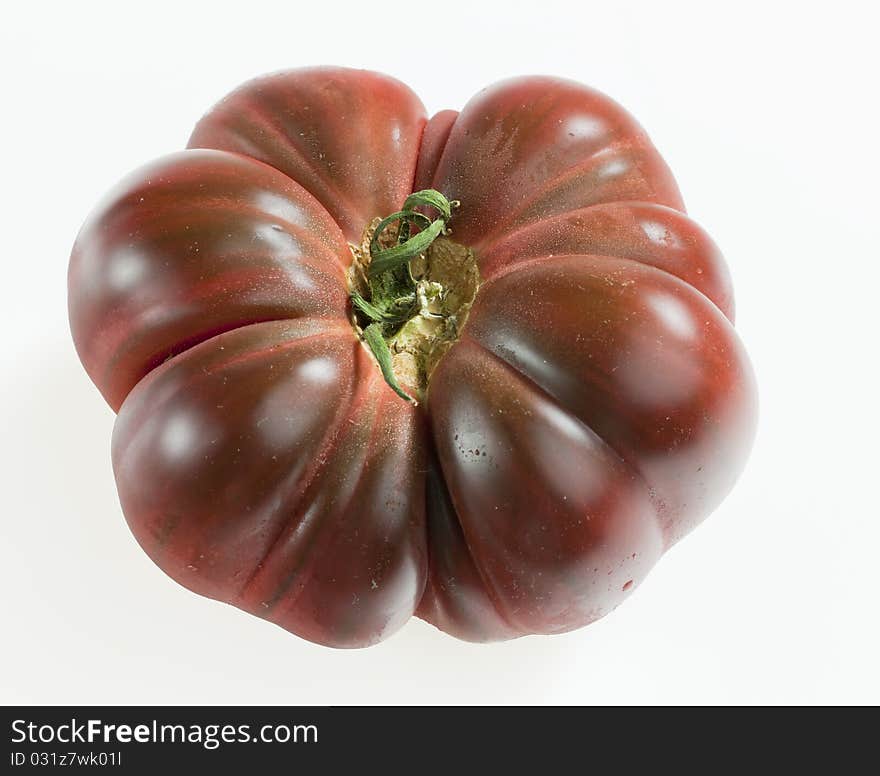 One tomato on white background