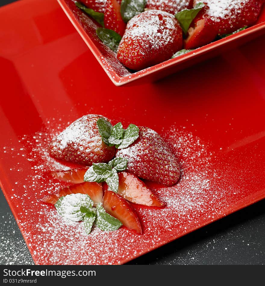 Sugared strawberries with mint leaves