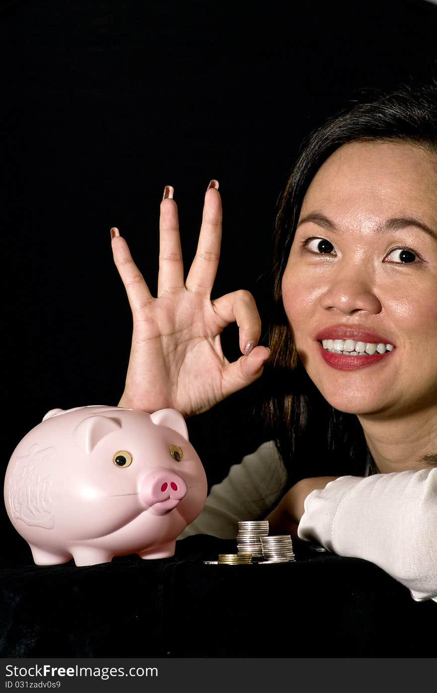 Young woman with pink piggy bank