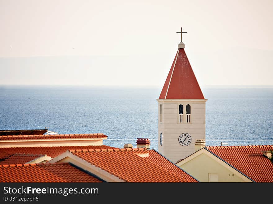 Chatolic church over roofs at sea.