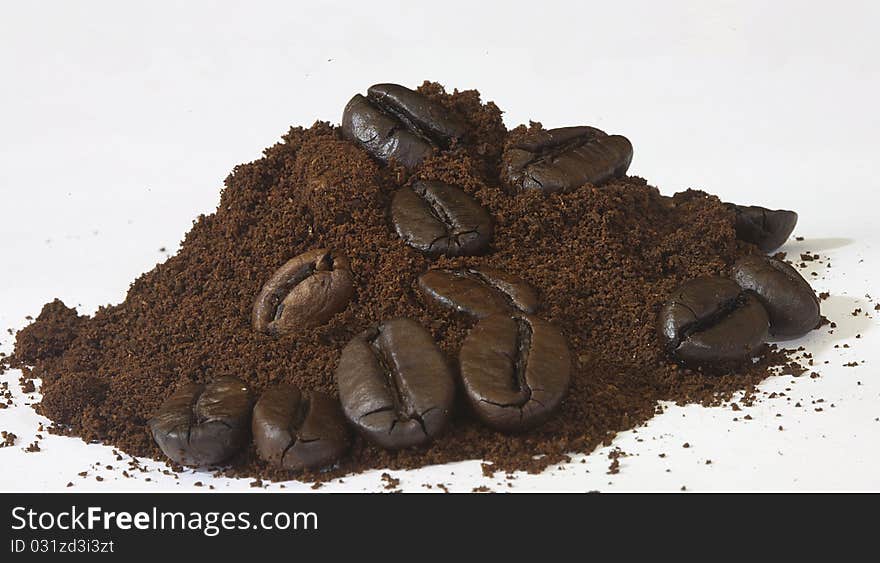 Lines with beans on coffee powder of the famous drink