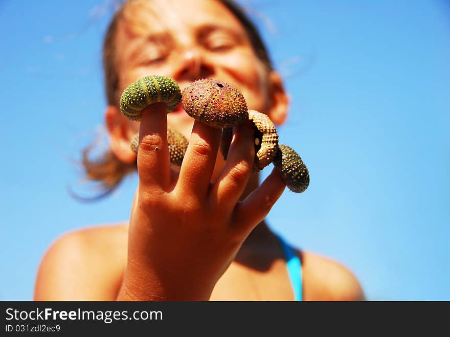 Little girl portrait with sea urchin shell