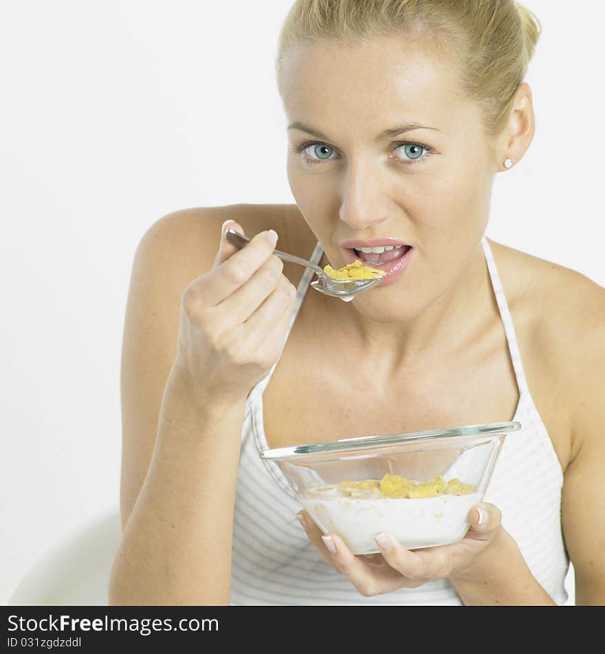 Portrait of young woman eating cornflakes