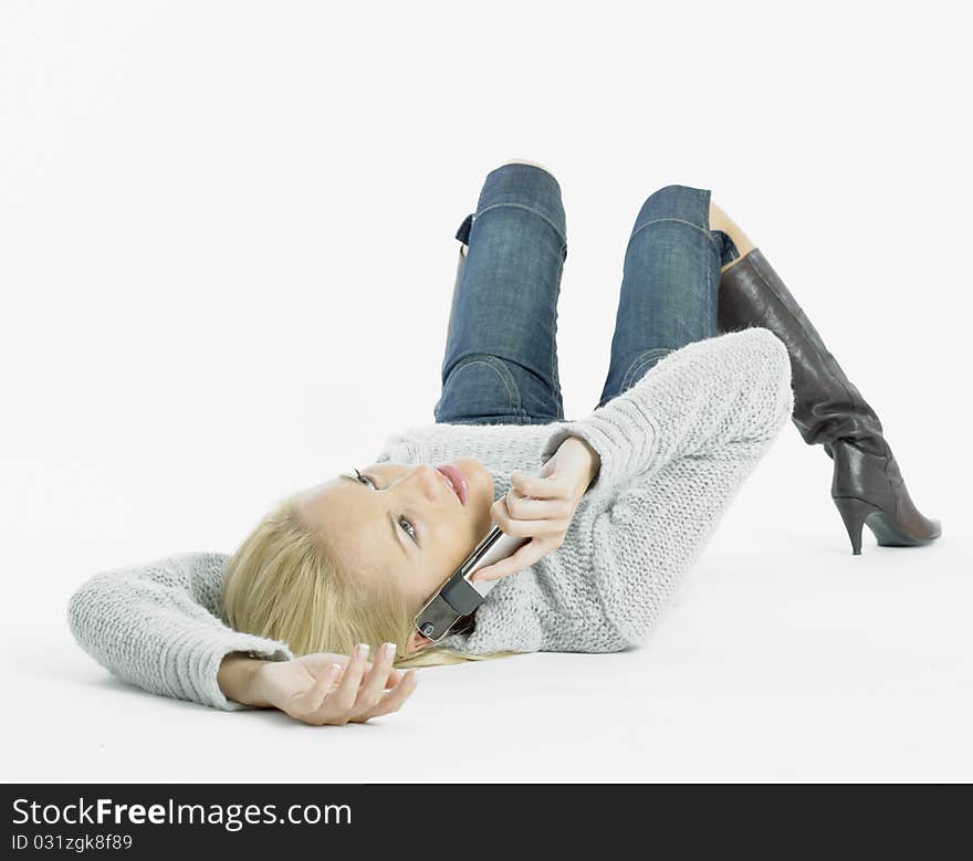 Calling young woman lying on the floor. Calling young woman lying on the floor