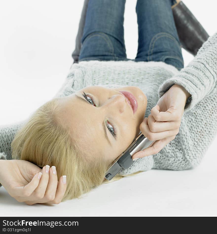 Calling young woman lying on the floor. Calling young woman lying on the floor