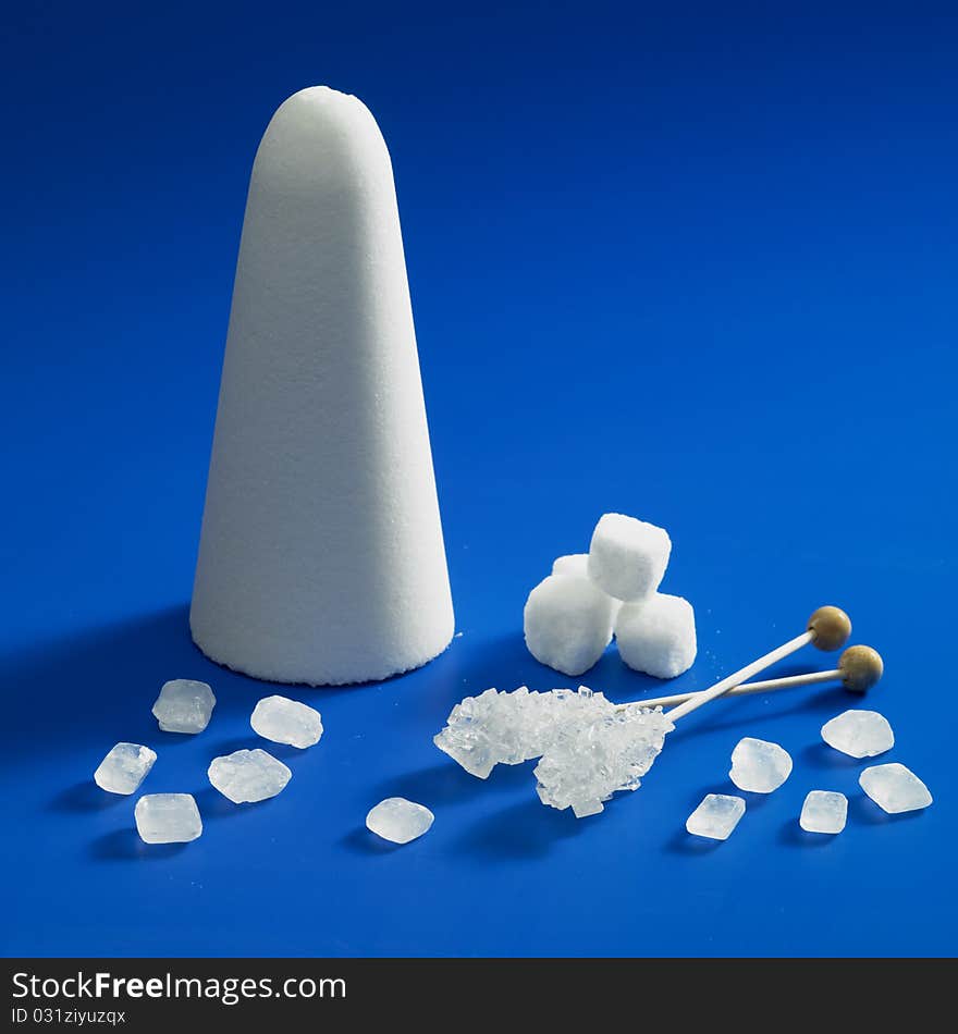 Still life of sugar on blue background