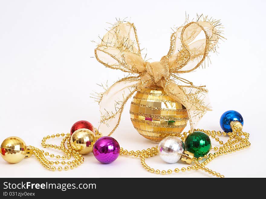 Gold Christmas bauble with colorful small balls on white background with copy space. Gold Christmas bauble with colorful small balls on white background with copy space.