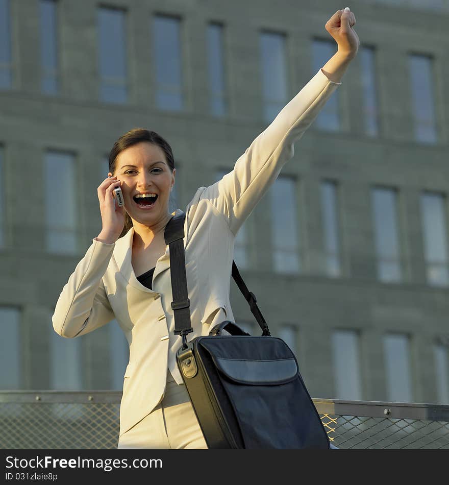 Telephoning businesswoman with a laptop