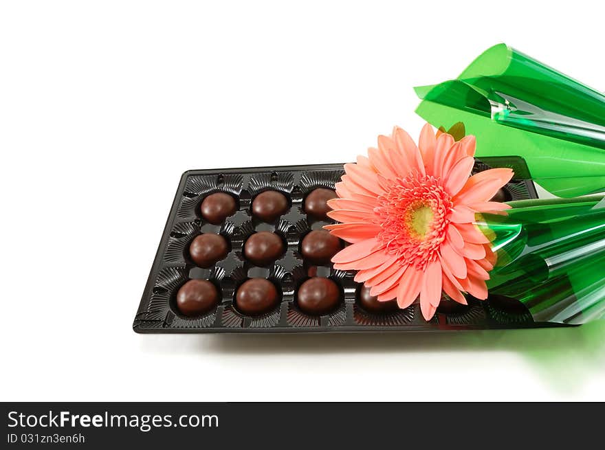 сhocolates with a flower are isolated on a white background