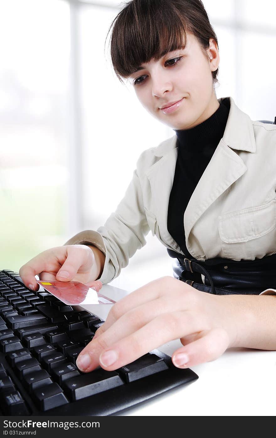 Woman's hands and laptop with a credit card in hand - modern office