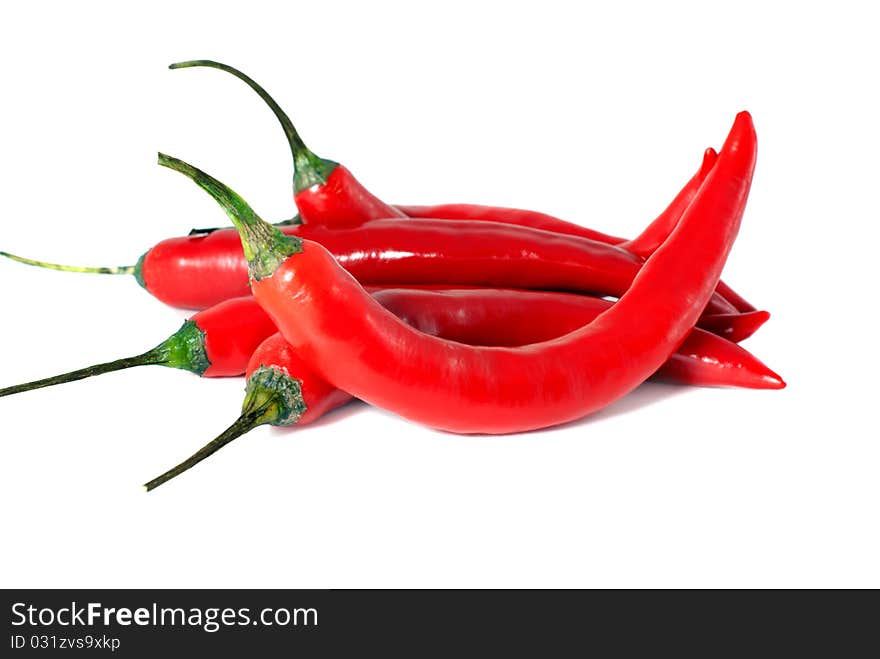 A handful of chili peppers on a white background