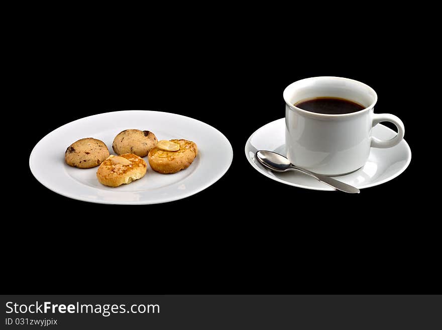 Black coffee in a white coffee cup with biscuit on plate. Black coffee in a white coffee cup with biscuit on plate