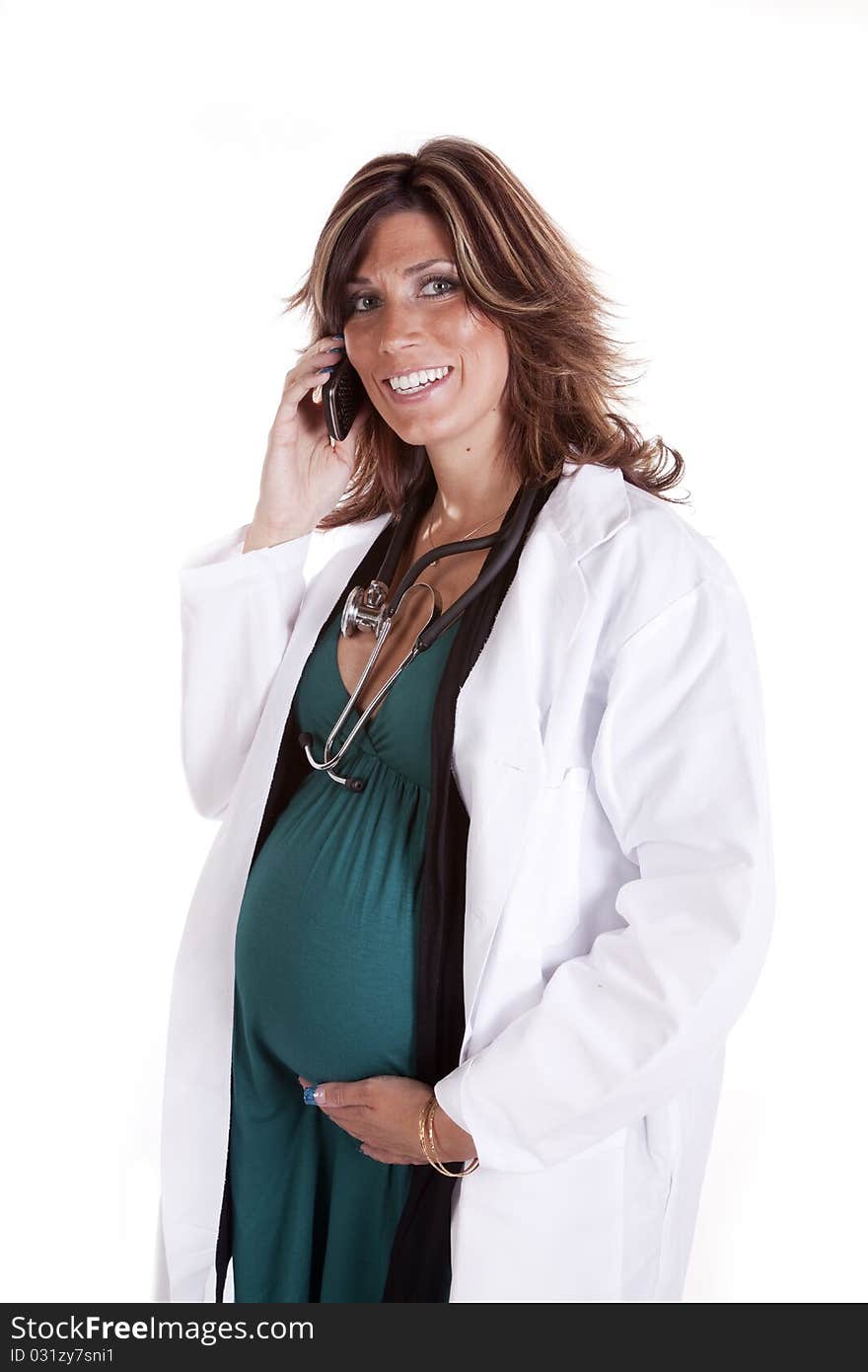 A woman doctor talking on her cell phone while she holds her belly. A woman doctor talking on her cell phone while she holds her belly.