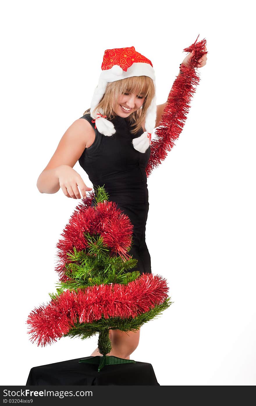 In the photo beautiful young girl around Christmas tree