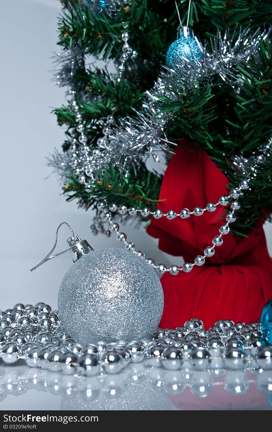 Christmas tree, white background, silver ball on the front. Christmas tree, white background, silver ball on the front