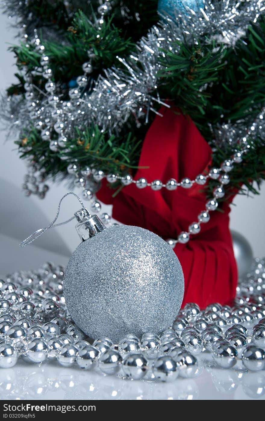 Christmas tree, white background, silver ball on the front. Christmas tree, white background, silver ball on the front