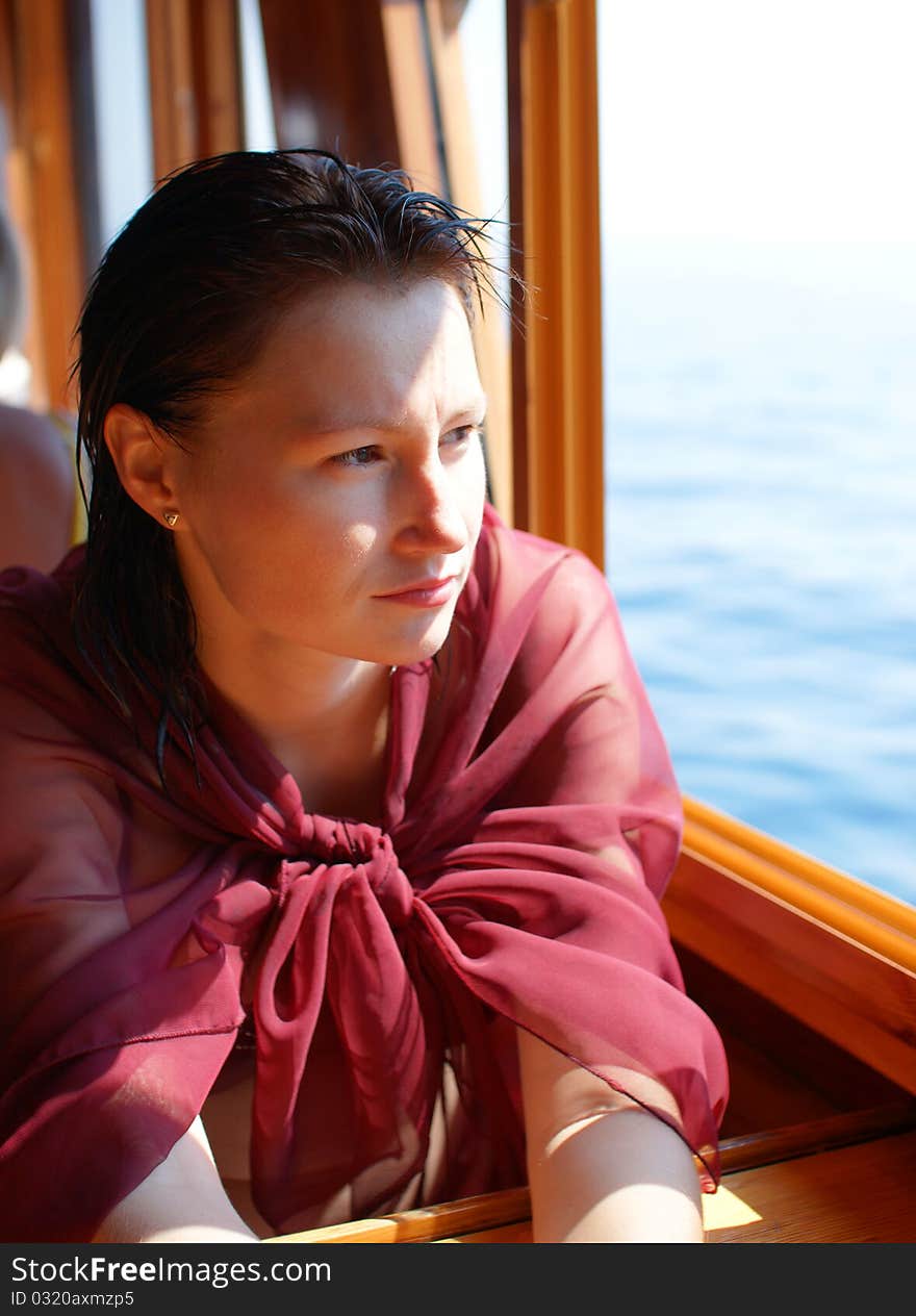 Woman near window on the ship