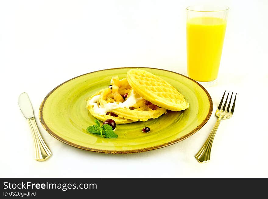 Waffles breakfast with orange juice on a white buckground