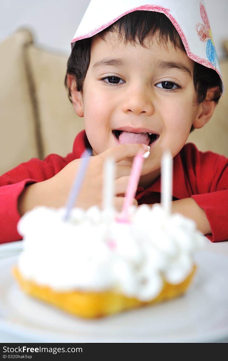 Little cute kid and his birthday cake