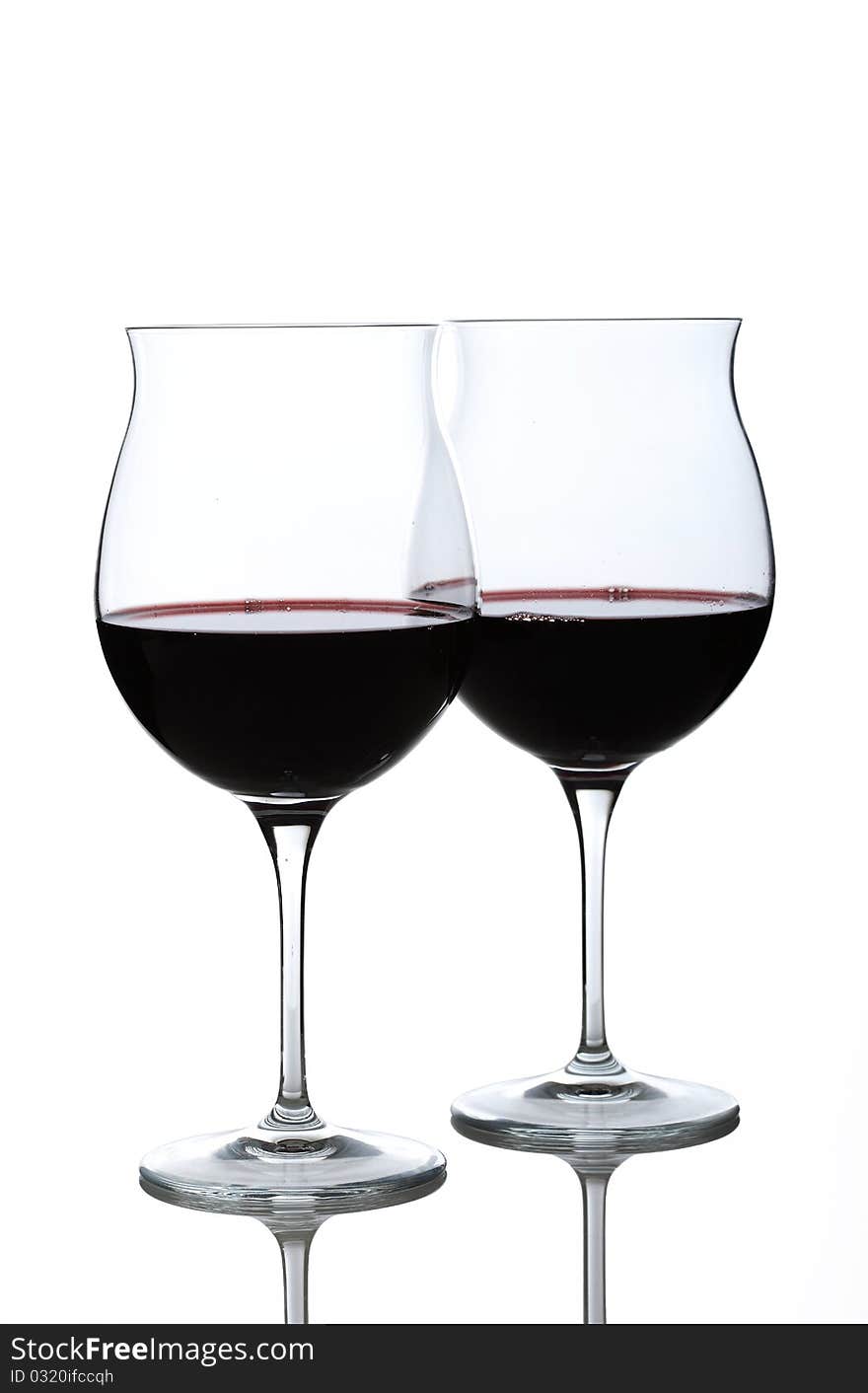 Half full wine glasses with red wine. Half full wine glasses with red wine