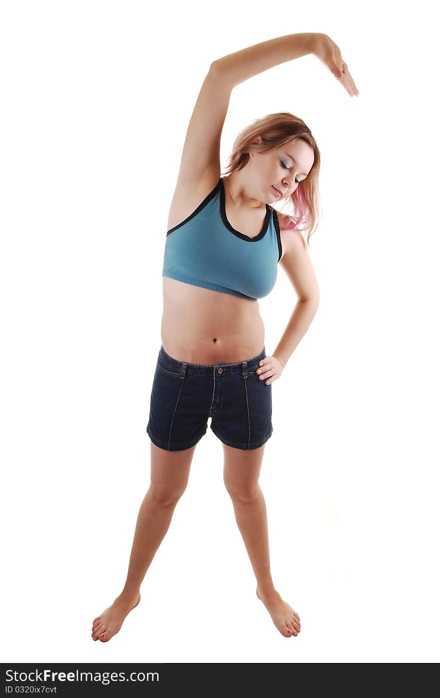 A young woman in shorts and a white undershirt and colorful socks lying on the floor, lifting her legs up, for white background. A young woman in shorts and a white undershirt and colorful socks lying on the floor, lifting her legs up, for white background.