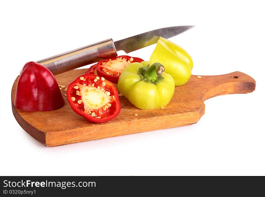 Cutting and preparing bell peppers on cutting board including red, orange, and green. Great ingredient for fajitas.