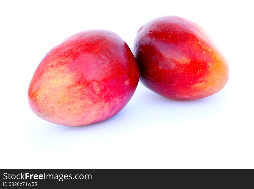 Two ripe mangos isolated on white background.