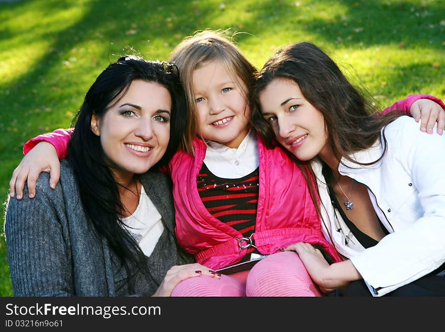 Young family taking healthy stroll through autumn park and have fun. Young family taking healthy stroll through autumn park and have fun