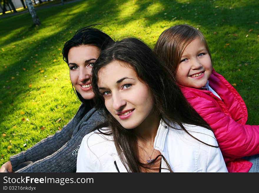 Young family taking healthy stroll through autumn park and have fun. Young family taking healthy stroll through autumn park and have fun