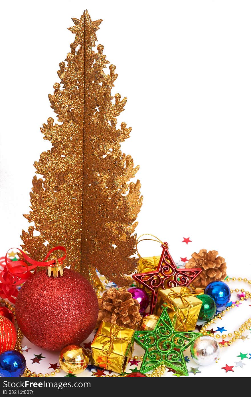 Colorful Christmas baubles and decorations next to golden tree isolated on white background with copy space. Colorful Christmas baubles and decorations next to golden tree isolated on white background with copy space.