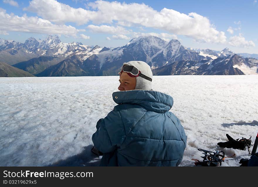 A teenager rests. Ascent on a mountain. A teenager rests. Ascent on a mountain.