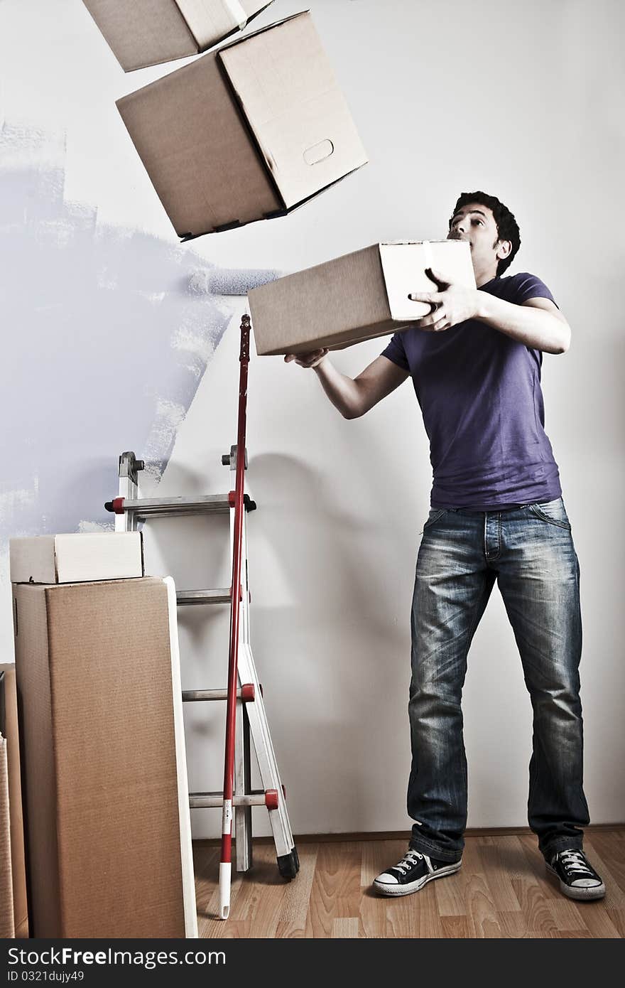 Man Carrying Stacked Boxes on moving day, desaturated image