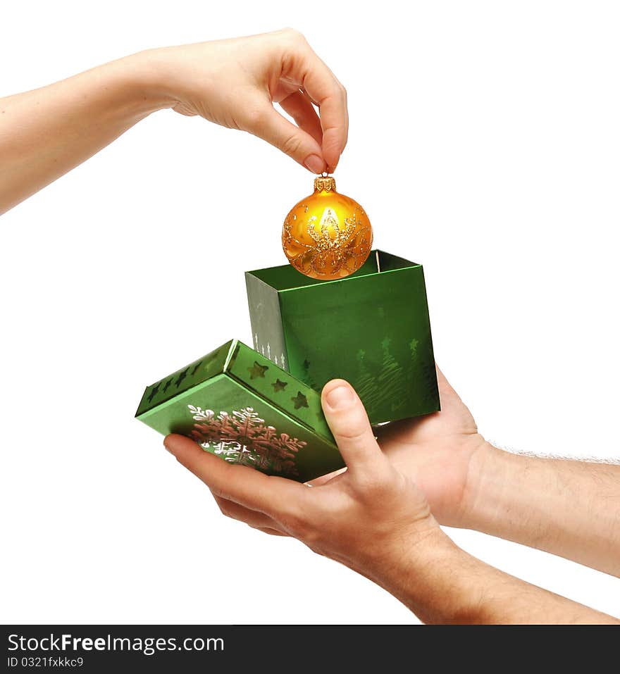 Female hand taking christmas ball out of box